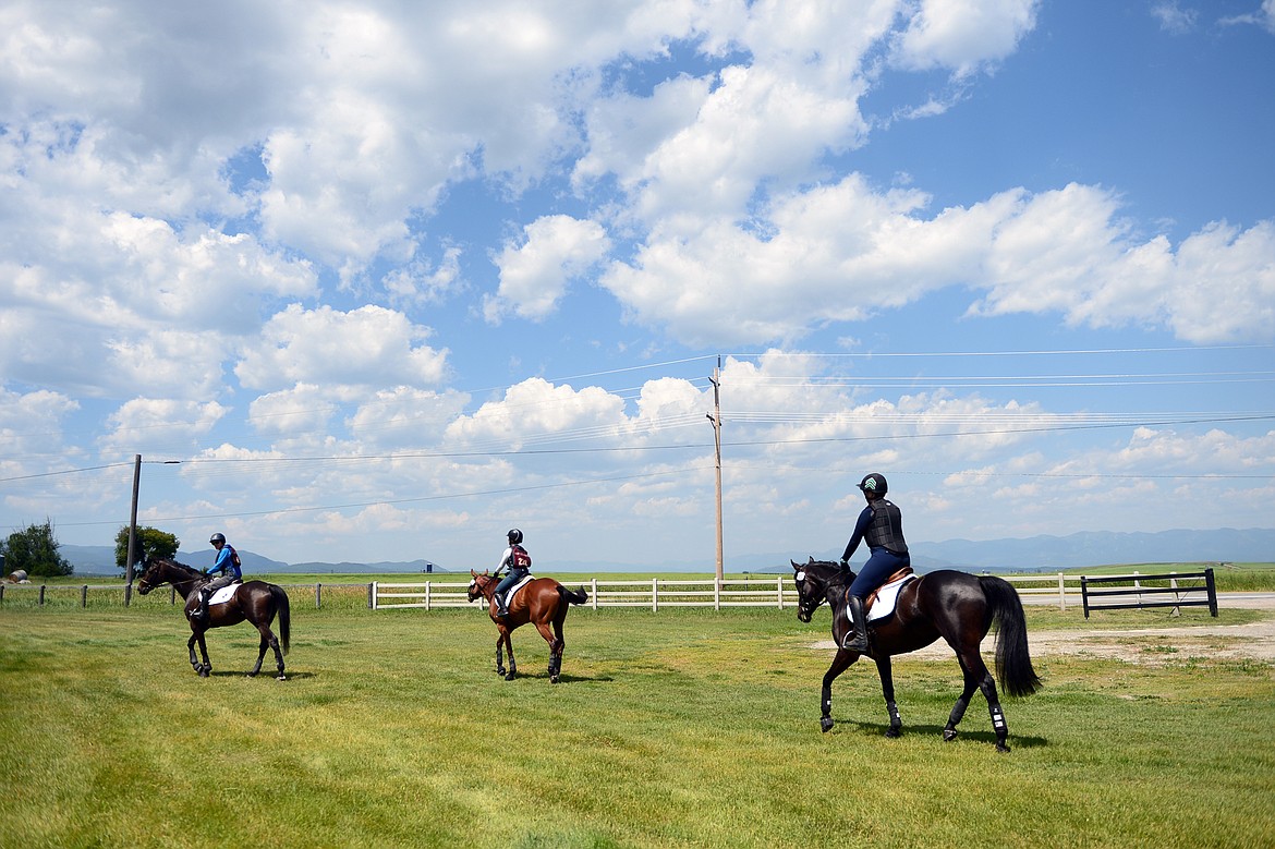 Riders take their horses along the course at Rebecca Farm on Wednesday. (Casey Kreider/Daily Inter Lake)