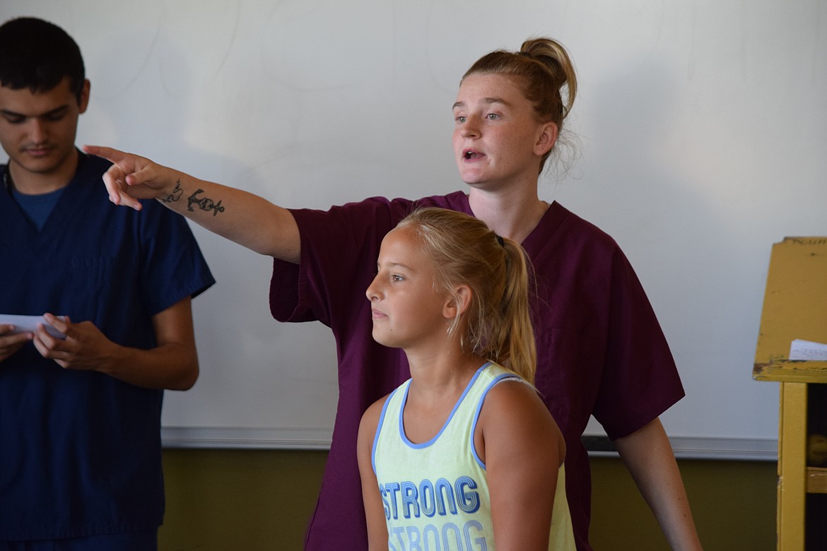 Charles H. Featherstone/Columbia Basin Herald
Job Corps student MacKenzie Schroeder organizes a game of Telephone as 10-year-old Izzy Purcell prepares to play.