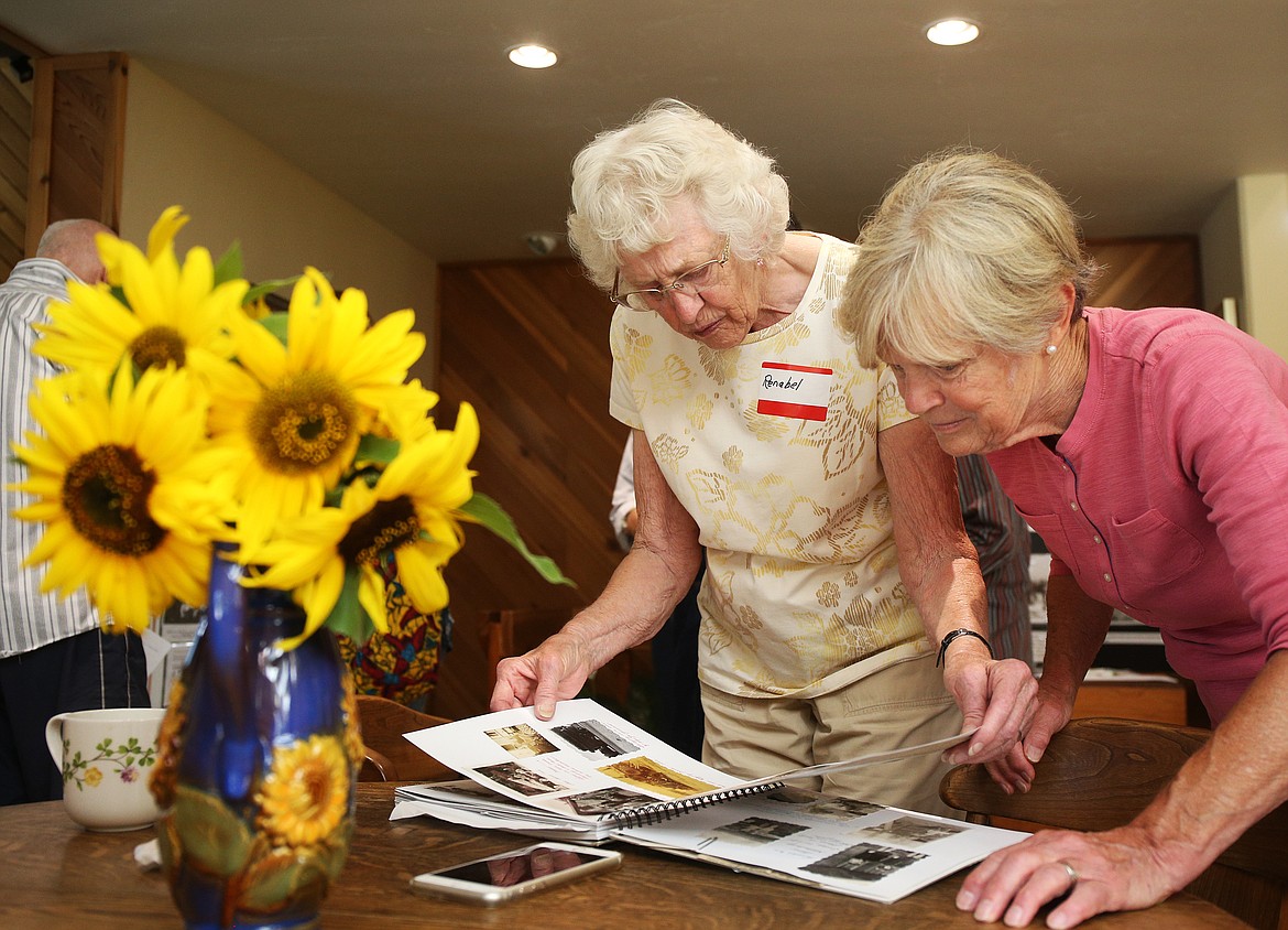 Sylvia Blaine, right, and Renabel Hattenburg Hawley look at pictures of the last existing one-room prairie schoolhouses in the area, the Upper Twin Lakes School. Renabel was in the last grade when the school closed in 1947. (LOREN BENOIT/Press)