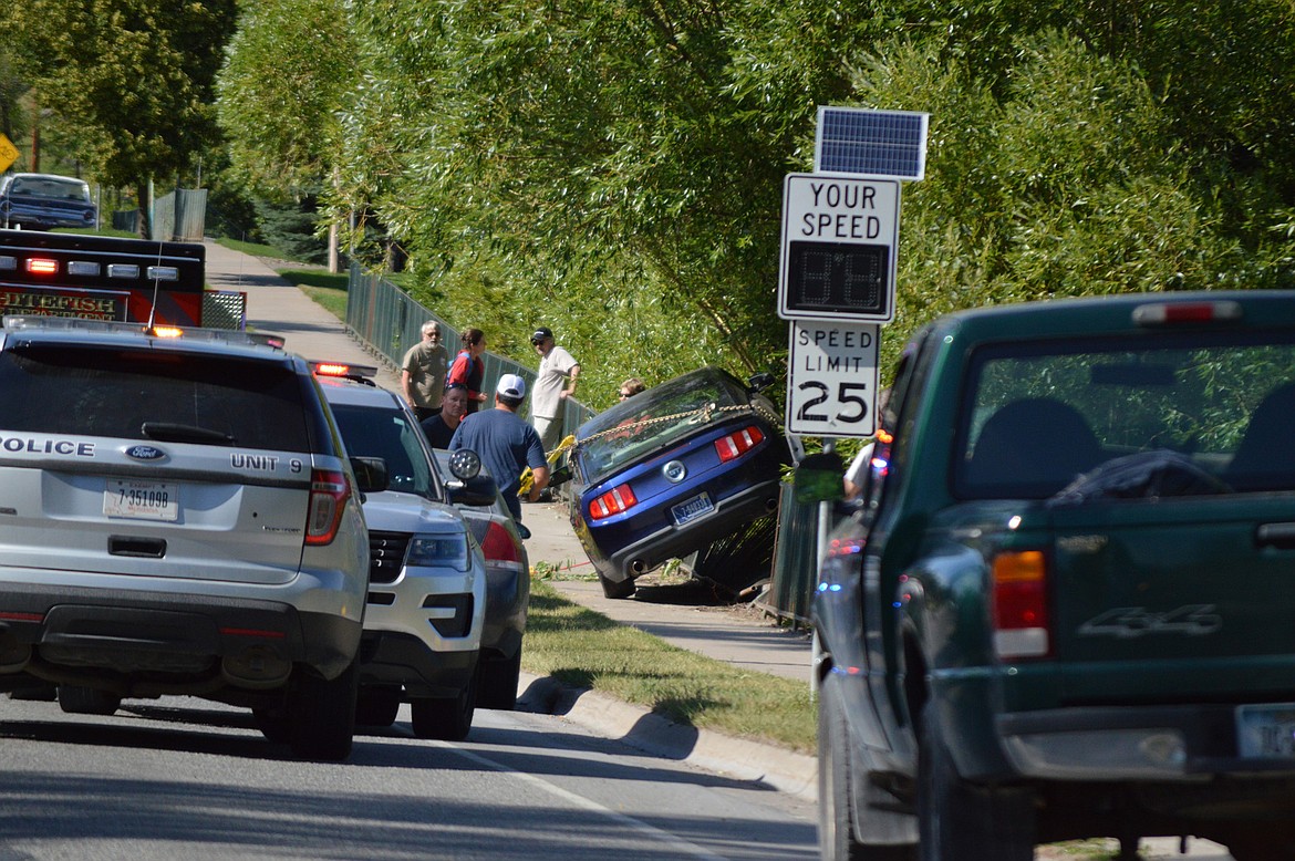 Whitefish first responders attended to the scene of a crash on Baker Avenue in Whitefish on Saturday evening. The driver of the vehicle was charged with DUI and vehicular assault after allegedly hitting two pedestrians. (Nelson Roosendahl photo)