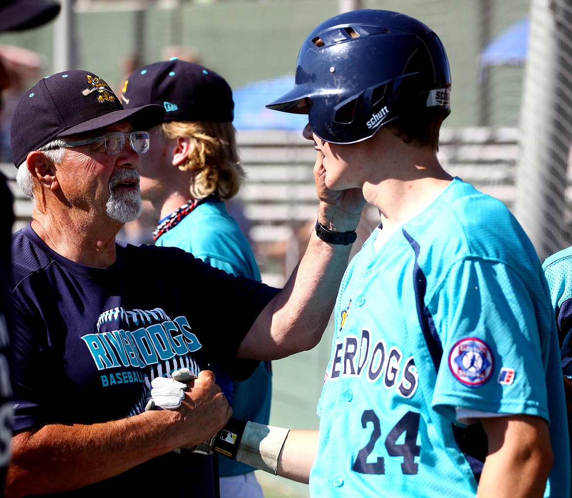 Rodney Harwood/Columbia Basin Herald
River Dogs No. 1 manager Randy Boruff, left, congratulates Cody Goodwin after hitting a home run in the second inning of Saturday's Northern Washington Senior Babe Ruth League championship game at Johnson-O'Brien Stadium.