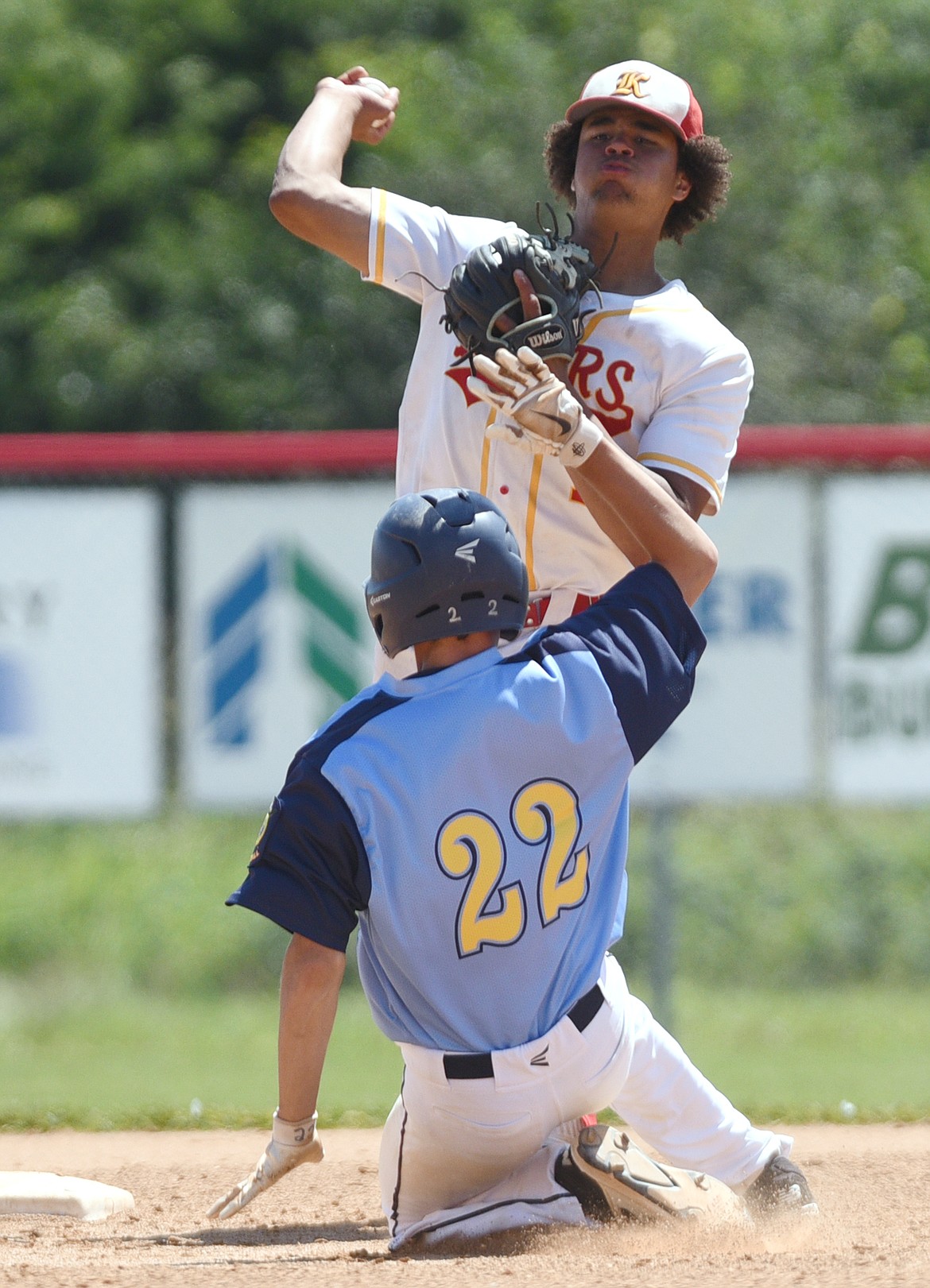 Kalispell Lakers AA second baseman AJ Jones throws to first to complete a game-ending double play against Great Falls AA at Griffin Field on Saturday. Sliding into second is Great Falls AA's Cal Cromwell. (Casey Kreider/Daily Inter Lake)