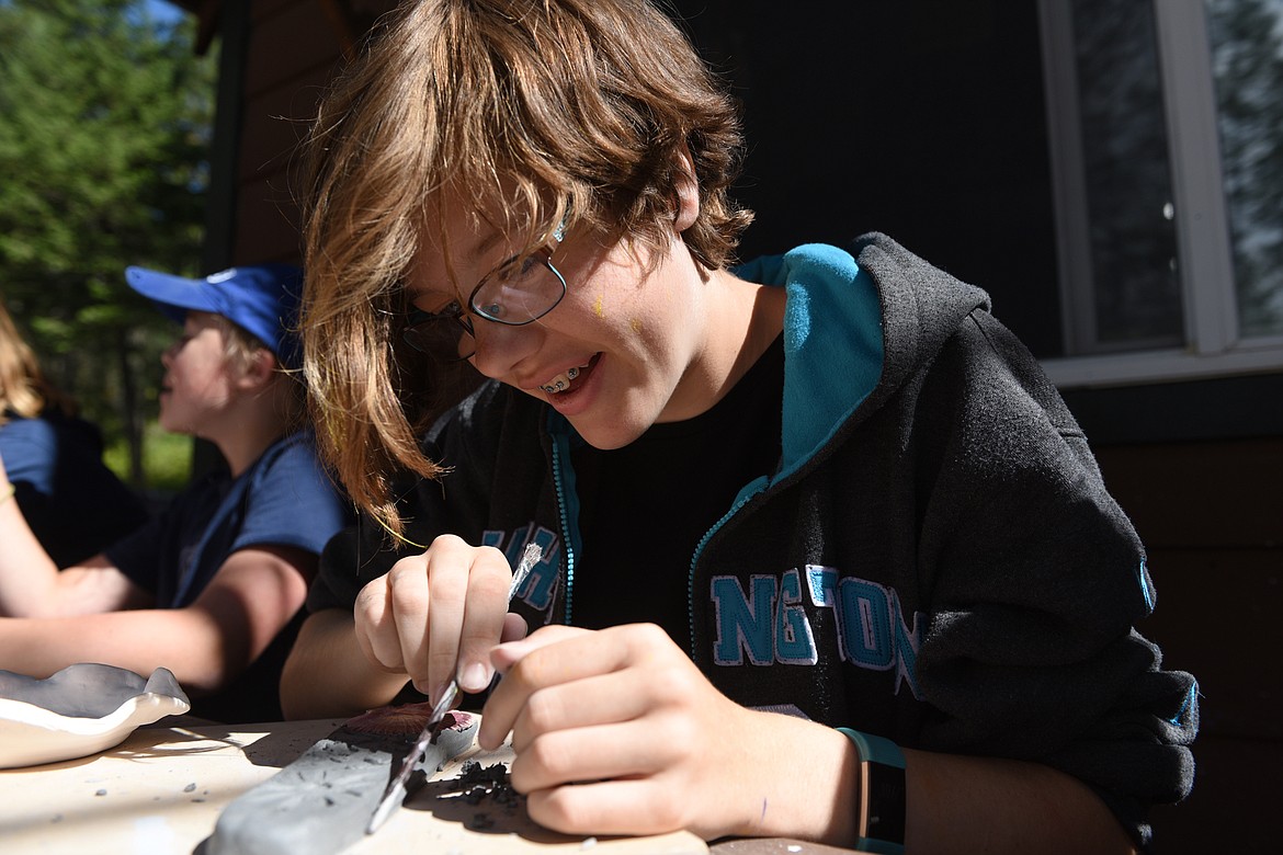 Bridgett Meskis of Kalispell works on a pottery project at Flathead Lutheran Bible Camp in Lakeside on Wednesday, July 11. (Casey Kreider/Daily Inter Lake)