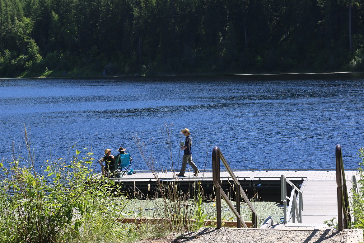 Photo by MANDI BATEMAN
Boundary Search and Dive Rescue volunteer Evan Phillips approaches people at Brush Lake to see if they might have seen anything that could help in their search.