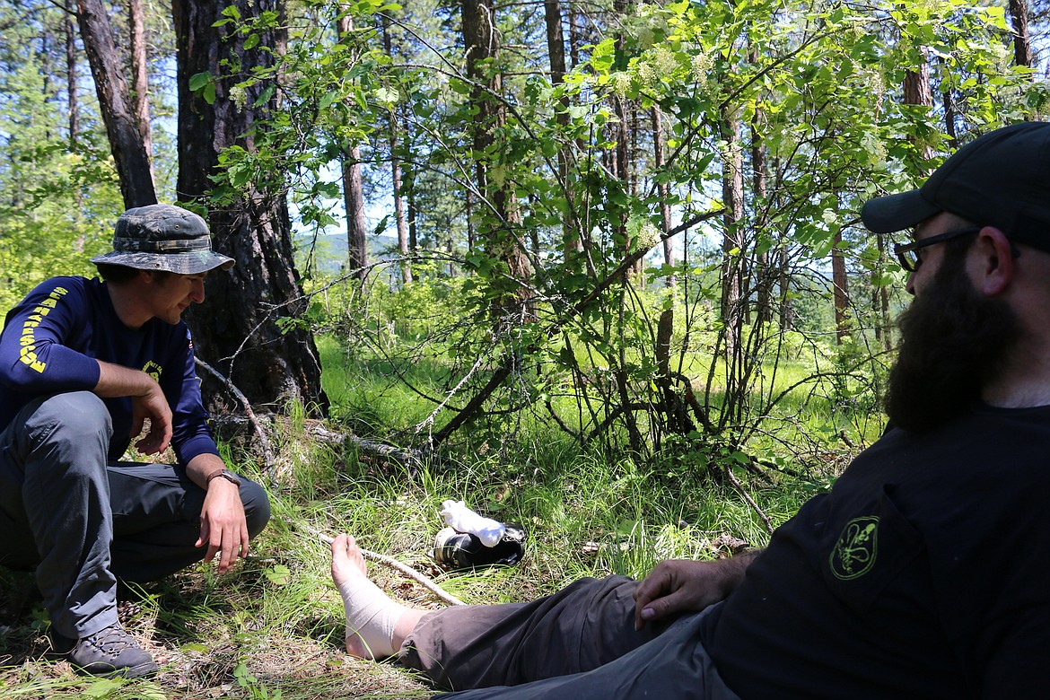 Photo by MANDI BATEMAN
When the missing subject was found, no detail was spared as SAR volunteer Stuart Yoder wrapped his ankle as the scenario called for him to have a sprained ankle.