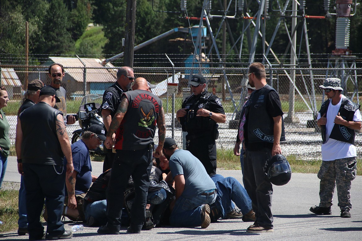 (Photo by MARY MALONE)
A motorcycle rider is surrounded after a drag race crash during Run Whatcha Brung in Oldtown on Saturday.