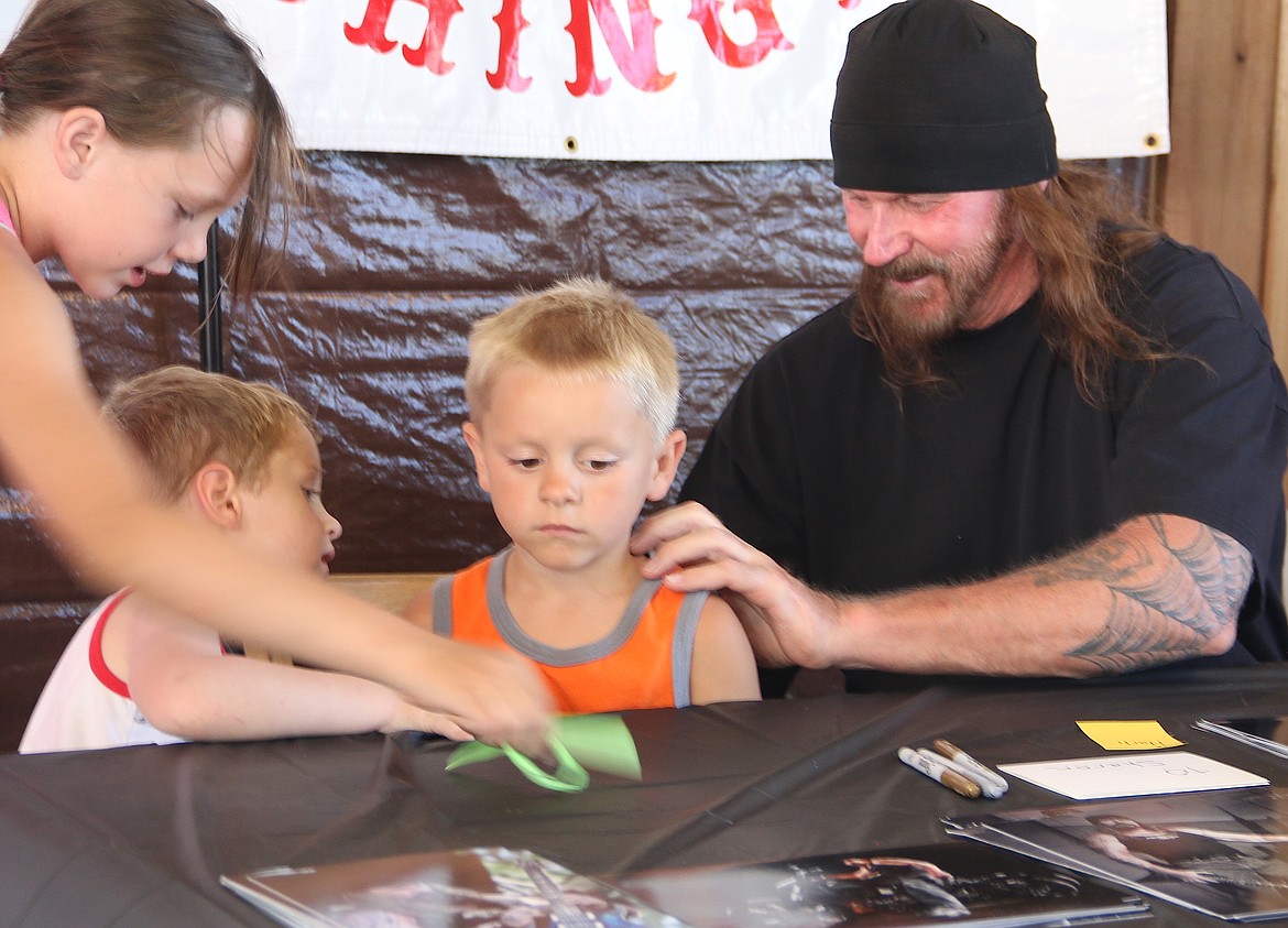 (Photo by MARY MALONE)
Rusty Coones from &#147;Sons of Anarchy&#148; signs a youngster&#146;s shirt during the Run Whatcha Brung event Saturday in Oldtown.