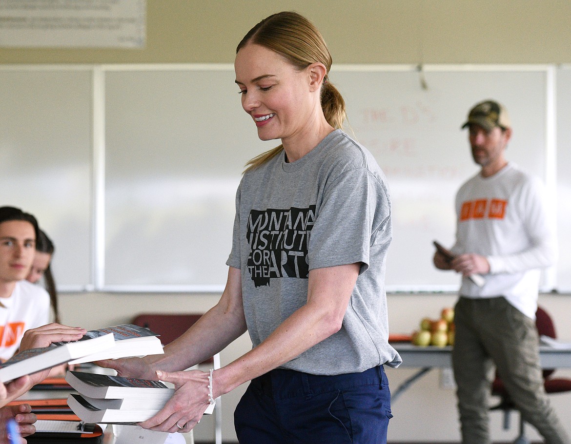 Actress Kate Bosworth hands out books at the beginning of class at The Montana Academy of the Arts at Flathead Valley Community College on Wednesday. (Casey Kreider/Daily Inter Lake)