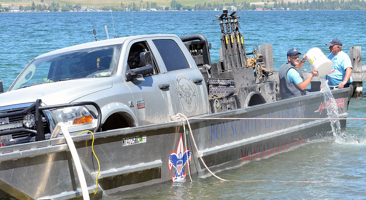 A DODGE Ram being transported by a barge tipped over near the Meadowlark Spur exit  Friday afternoon in Flathead Lake. (Photo by Jason Blasco/Lake County Leader)