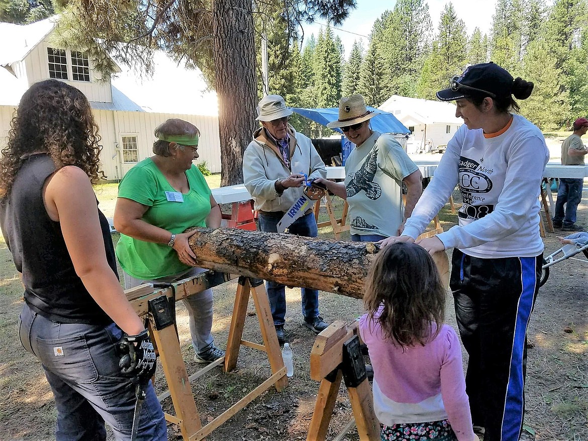 More than four generations of Passport in Time volunteers peel logs to make beds during last week&#146;s program at the Savenac Historic Tree Nursery near Haugan. (Photo by Erika Karuzas)