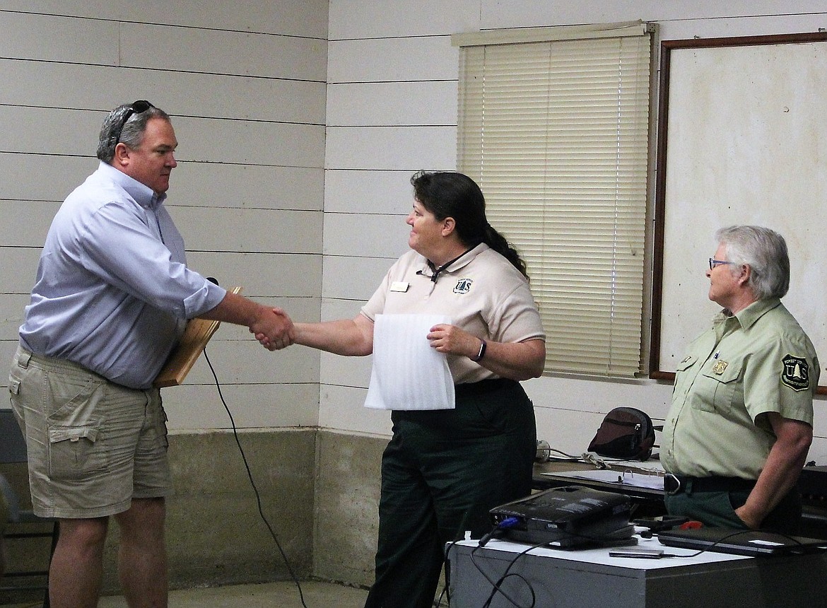 Superior School Superintendent Scott Kinney accepted an Outdoor Education award from Acting Lolo National Forest Service Supervisor, Sara Mayben and Superior District Ranger, Carole Johnson for the school&#146;s 50-year old Outdoor School program. (Photo by Kathleen Woodford/Mineral Independent)