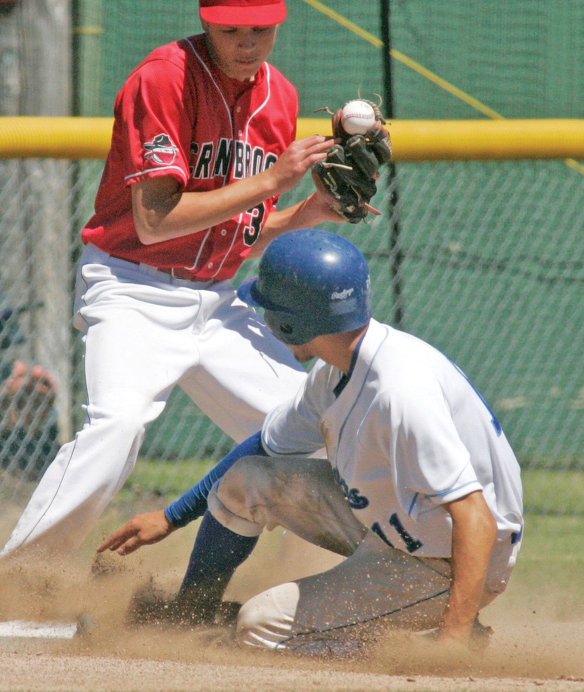 Cranbrook third baseman Quinn Grist is late on the tag as Jeff Offenbecher advances to third on a wild pitch with two out in the bottom of the first inning Saturday. The play was during the second game of a doubleheader. (Paul Sievers/The Western News)