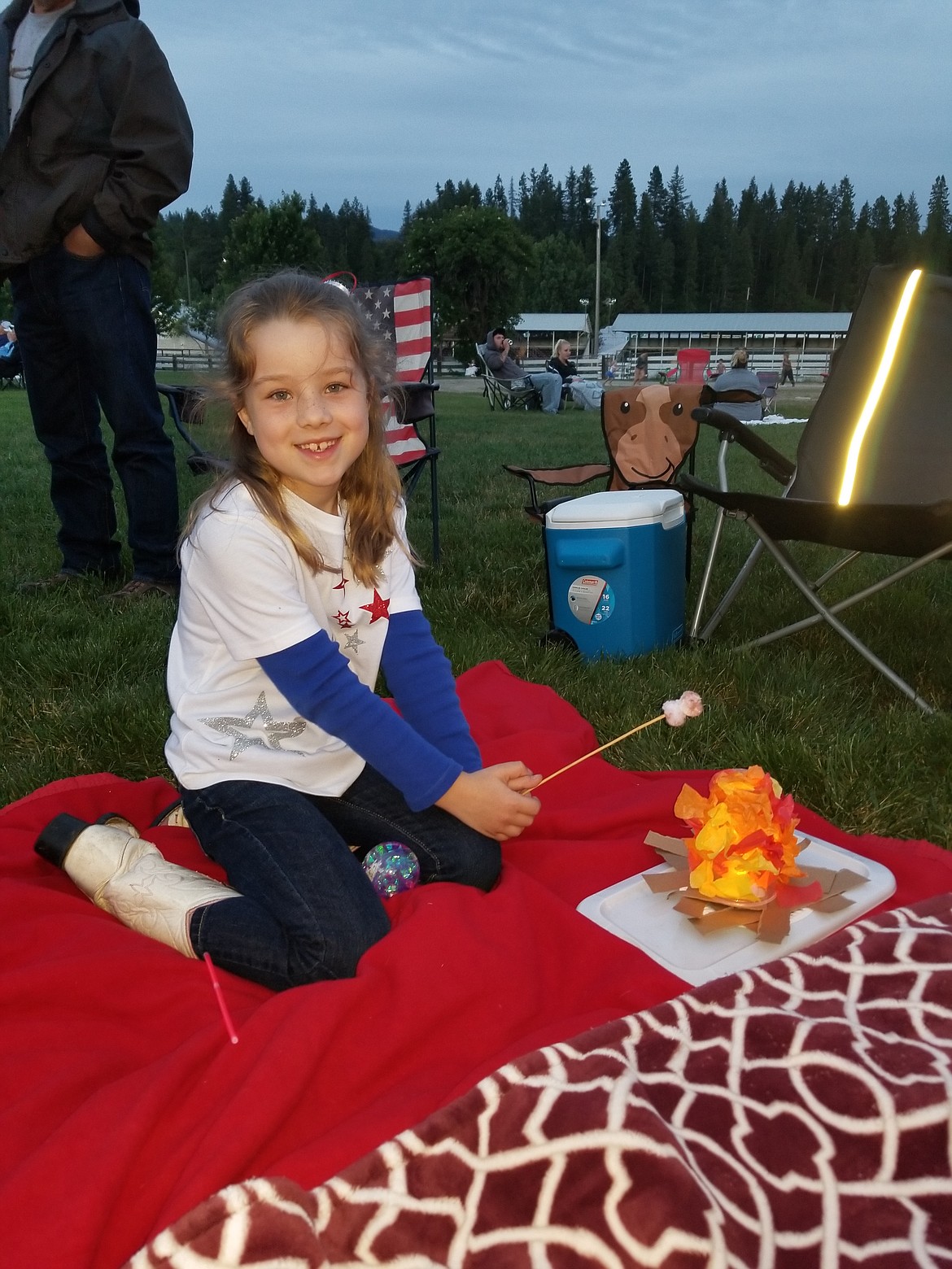 Photo by MANDI BATEMAN
Seven year old Shelby Roberge built herself a miniature campfire at the fairgrounds while awaiting the fireworks.