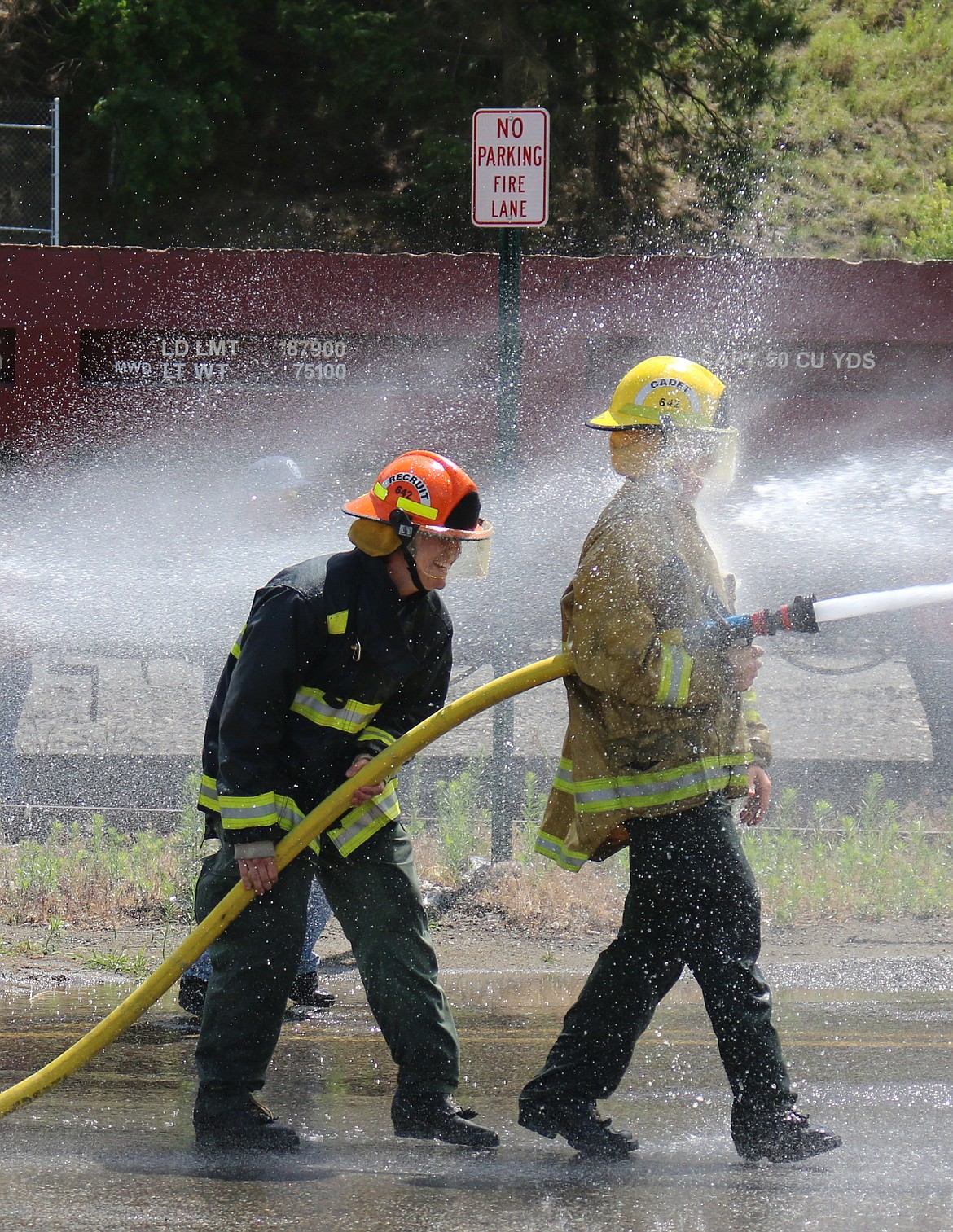 Photo by MANDI BATEMAN
The competition was all in good fun, as these firefightes get a soaking from the opposing team.