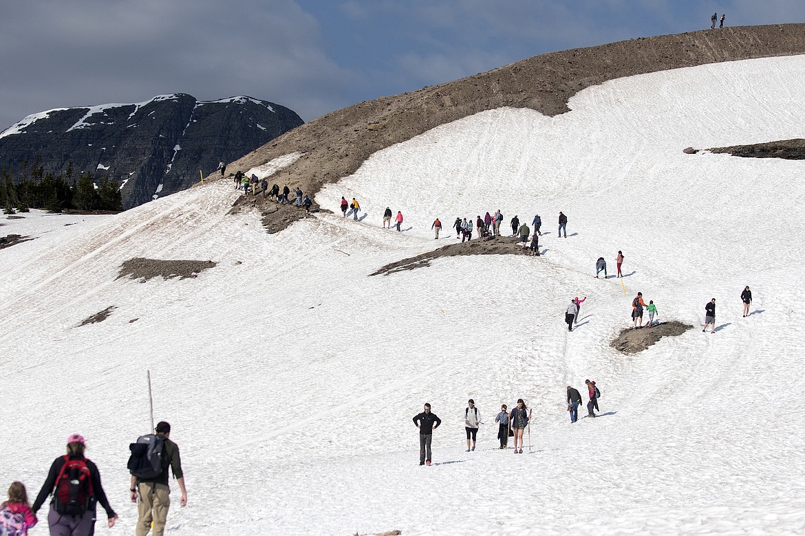 Hundreds of tourists were already on the snow-covered Hidden Lake Trail by 8 a.m. Saturday. (Jeremy Weber photo)