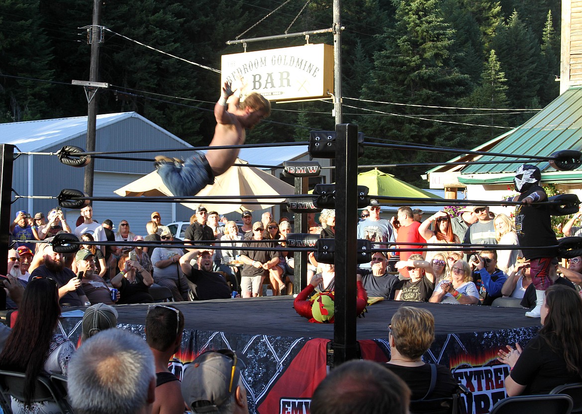 Outlaw goes off the top rope for a tadpole splash.