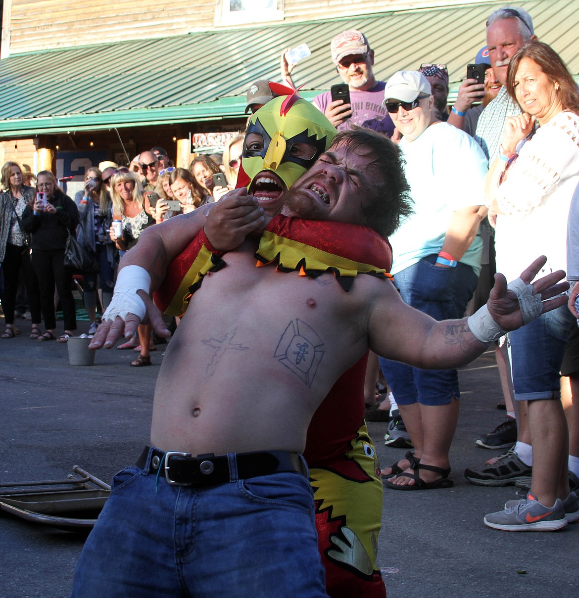 Lil&#146; Pecker chokes out Outlaw during a ringside brawl.