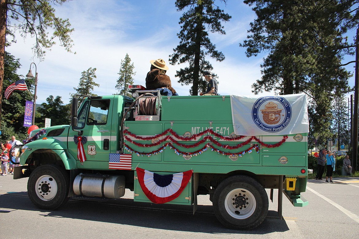 Smoky Bear greets people atop a Forest Service vehicle during the parade in St. Regis on the Fourth of July. (Kathleen Woodford/Mineral Independent)