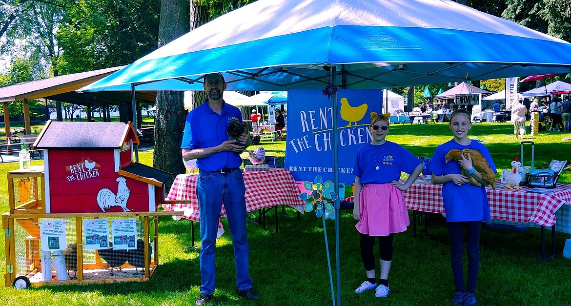 The Karsten family&#146;s Rent the Chicken booth at the recent Family Day in the Park at Coeur d'Alene City Park. From left: Erick and his daughters Marlee, 11, and Macy, 13. (Courtesy photo)