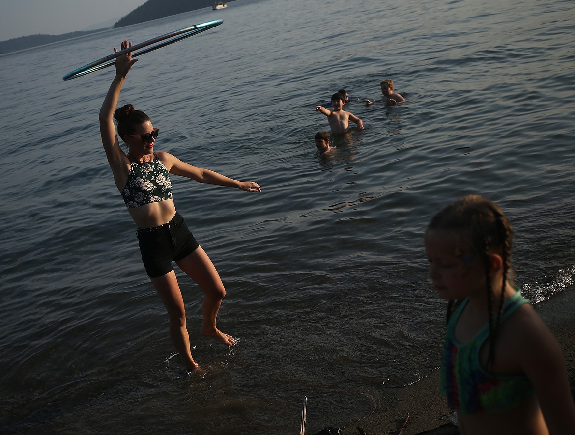 Olivia Holm spins a hula hoop as the sun starts to set Friday evening at SoulShine's Full Moon Gathering 2018 at Sanders Beach. (LOREN BENOIT/Press)