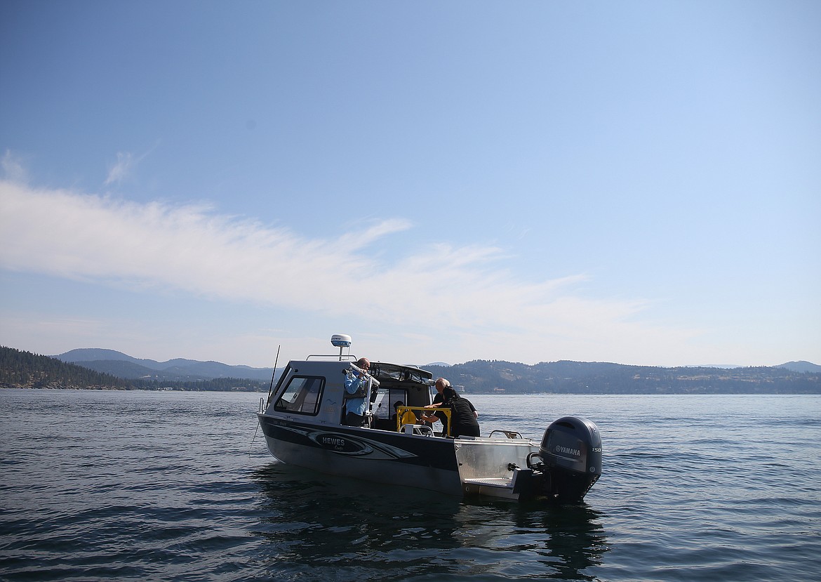 A University of Idaho Coeur d'Alene research team runs preliminary checks before lowering a submersible drone into Lake Coeur d'Alene near Stevens Point. This fall, the drone will test oxygen and temperature levels, water clarity and record lake bed video. (LOREN BENOIT/Press