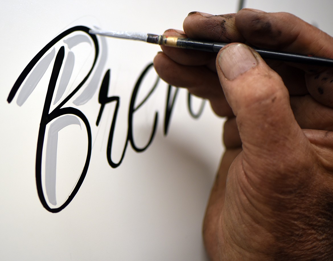 Gary Gudmundson displays some of his lettering skills.