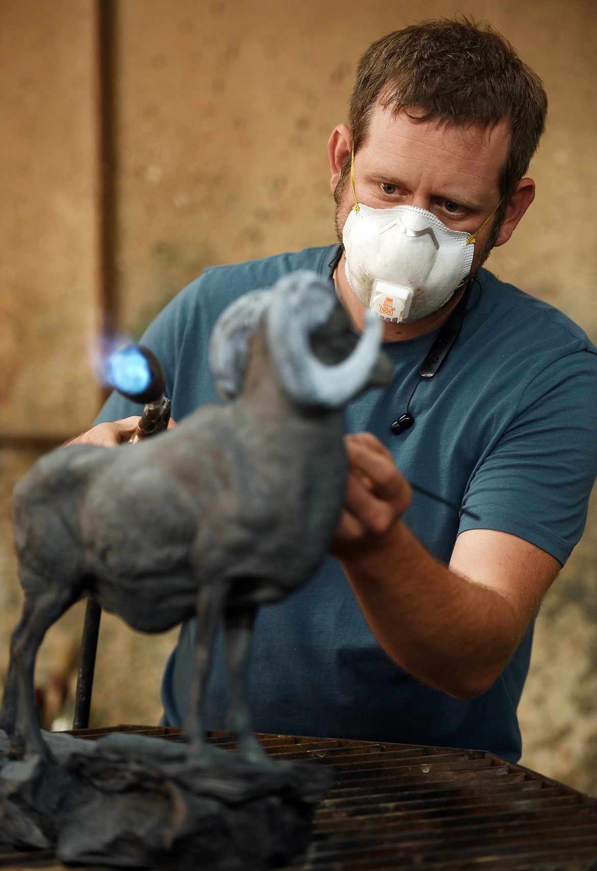 Jeremy Fairchild adds the patina to a bronze sculpture on Monday afternoon, July 17, at Kalispell Art Casting in Evergreen.(Brenda Ahearn/Daily Inter Lake)