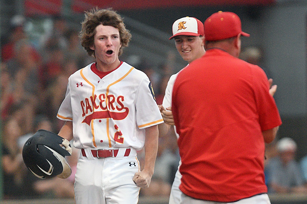 Kalispell Lakers AA's Ben Corriveau celebrates after scoring on a RBI single by Randy Stultz in the bottom of the sixth inning against the Helena Senators in the Class AA state tournament at Griffin Field on Saturday. (Casey Kreider/Daily Inter Lake)