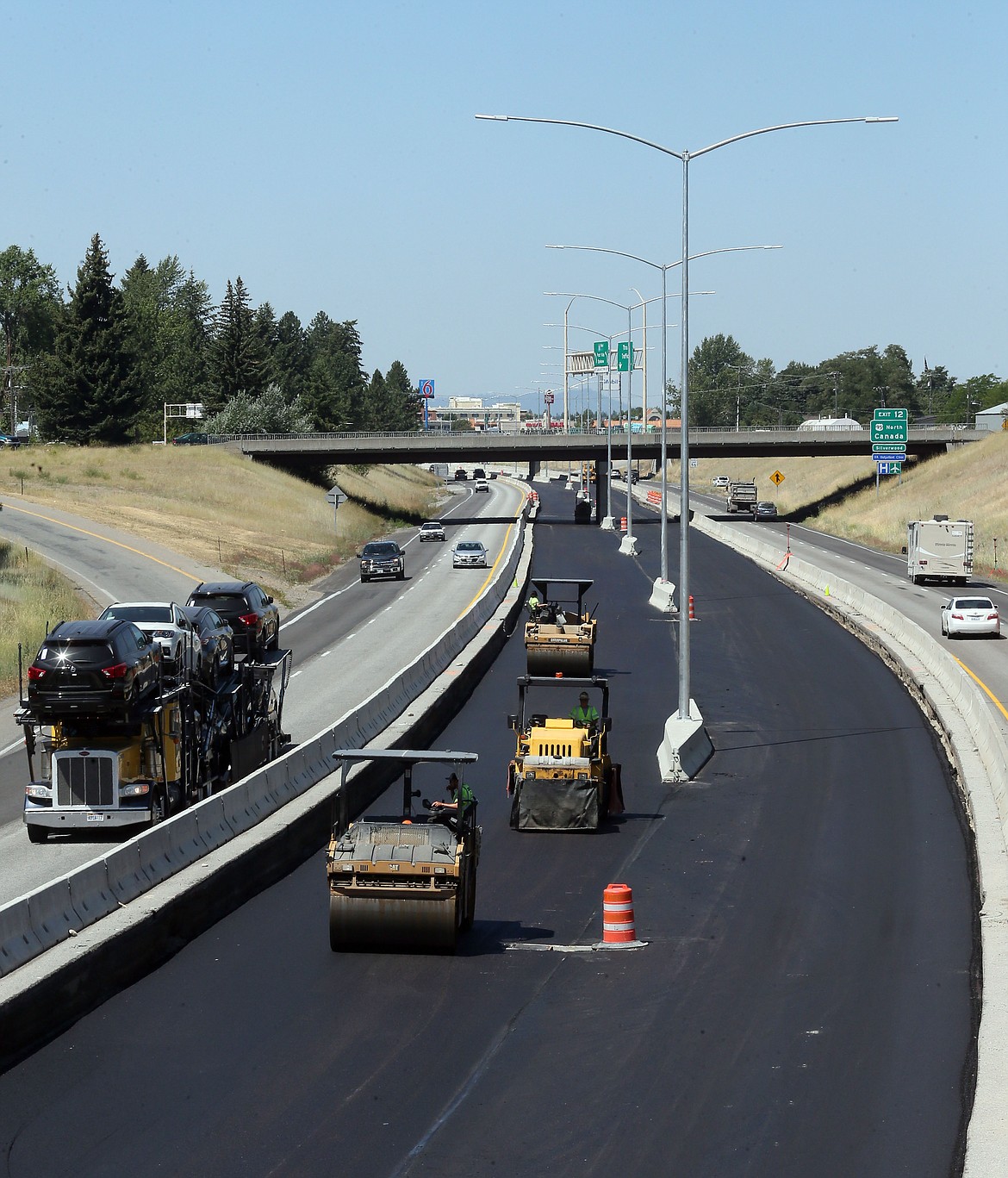 JUDD WILSON/Press
Street lights rise from the new median while construction workers smooth out asphalt on Interstate 90 near Seventh Street in Coeur d&#146;Alene on Tuesday.