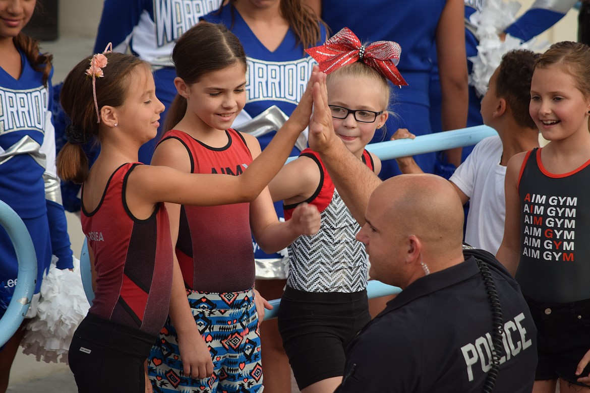 Charles H. Featherstone/Columbia Basin Herald
An MLPD officer exchanges high-fives with the audience at the lip-sync challenge Thursday.