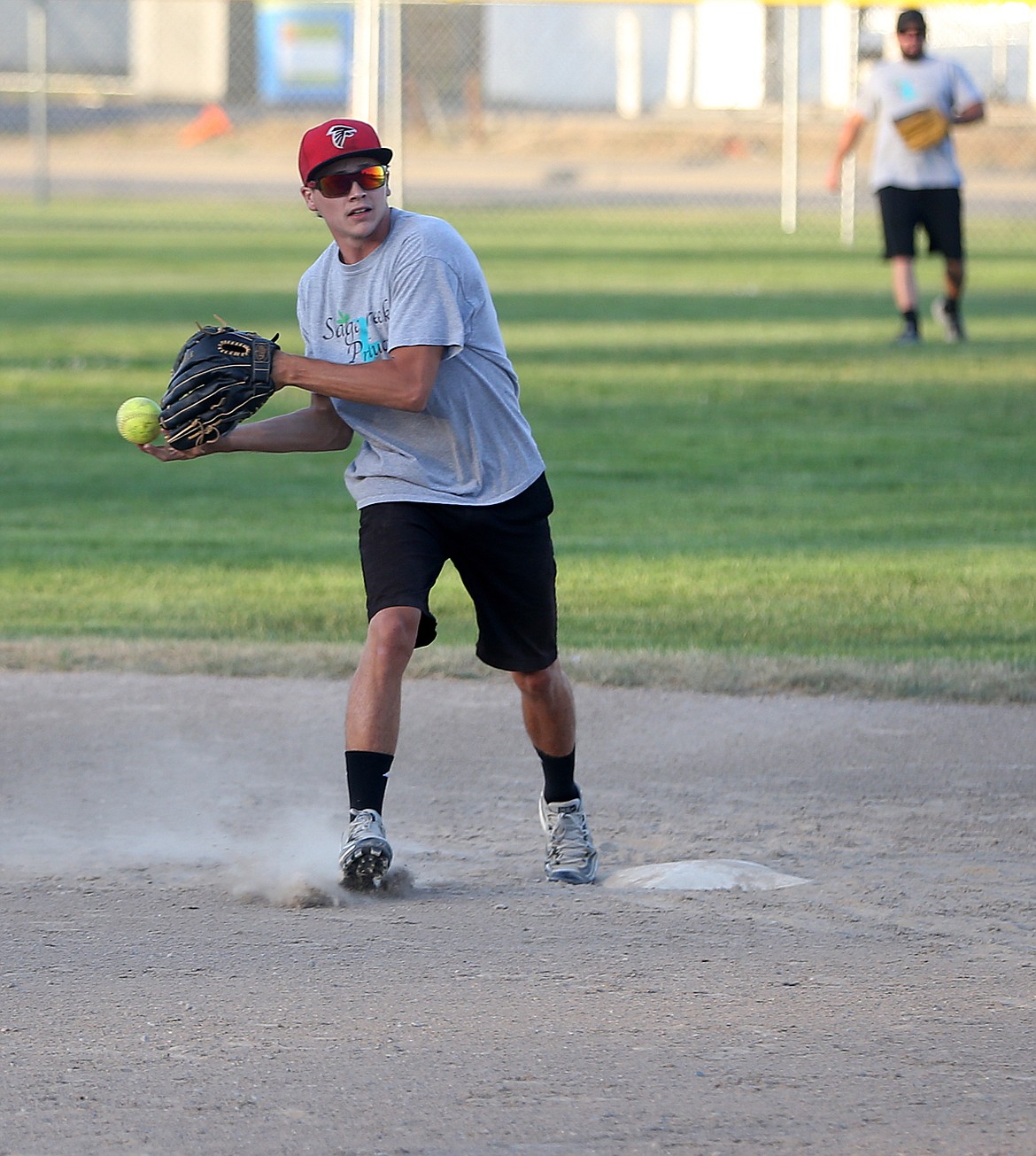 Gary Doney of Sage Creek Products steps on second base and throws to first in a game against Northwest Specialty Hospital on Thursday at Ramsey Park.