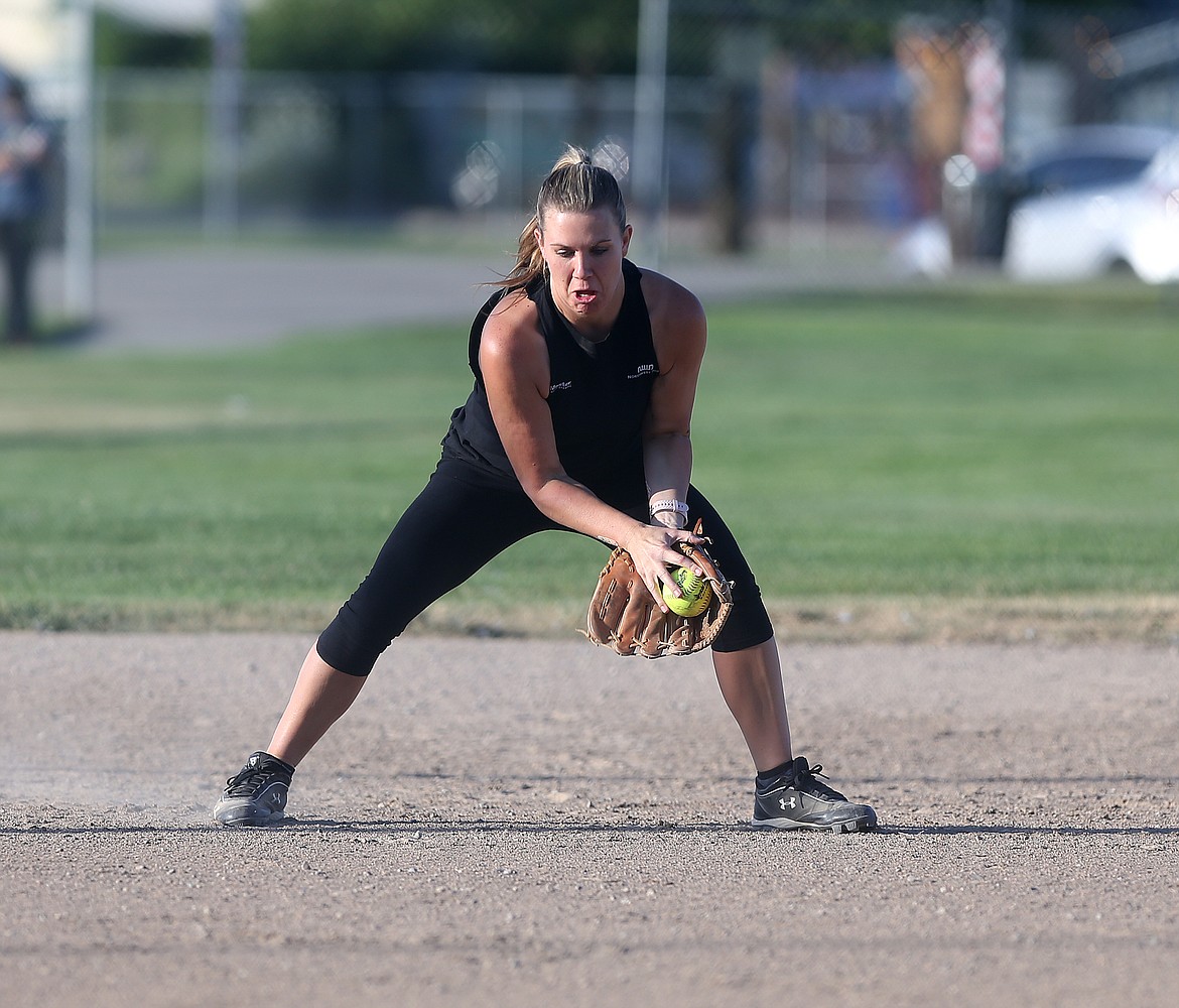 Tara Rutherford of Minton Overhead Door LLC fields a ground ball in a rec softball game against Mountain View Bible Church.