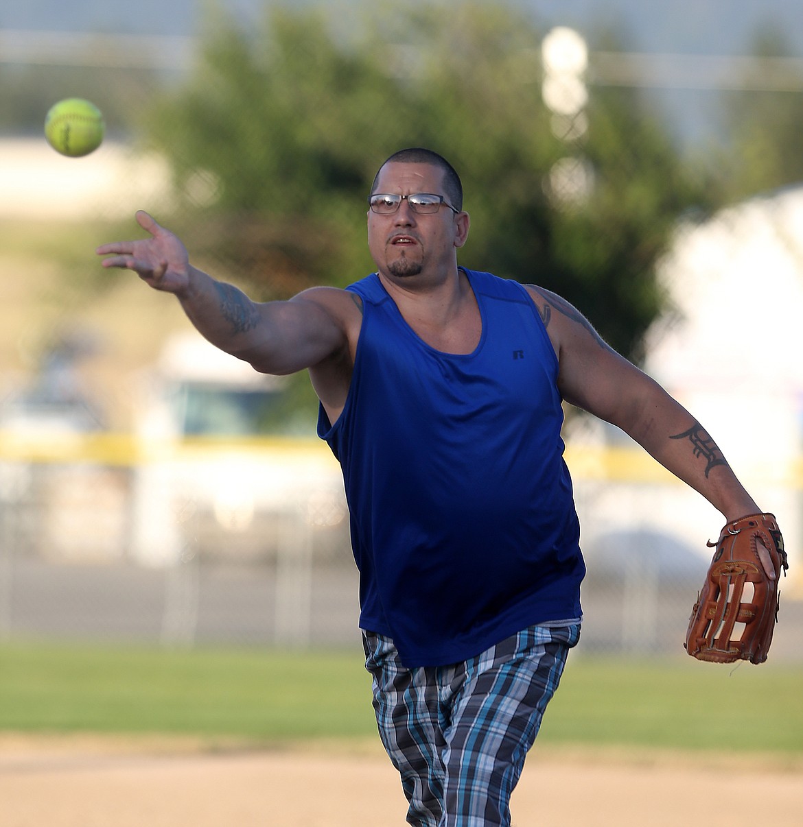 Dilan McCliggott of Kootenai Recovery Center throws a pitch in a rec softball game against Sage Creek Products on Thursday evening at Ramsey Park.