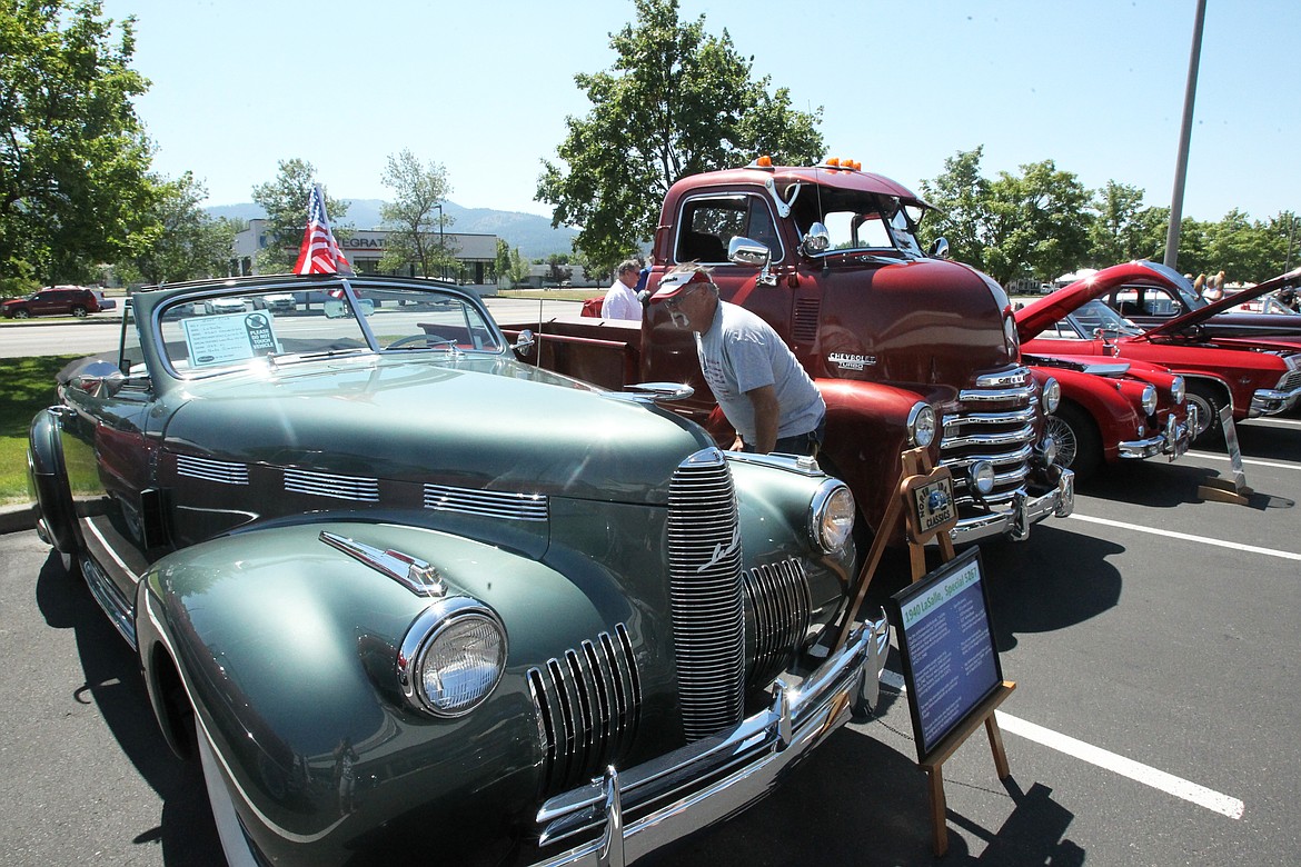 Randy Kelleher of Post Falls admires a 1940 LaSalle Special 5267 during the North Idaho Classics Car Club&#146;s Rod Run at Tedder Industries in Post Falls on Saturday. &#147;I&#146;m very impressed,&#148; Kelleher said. &#147;I&#146;m taking my time.&#148; (DEVIN WEEKS/Press)