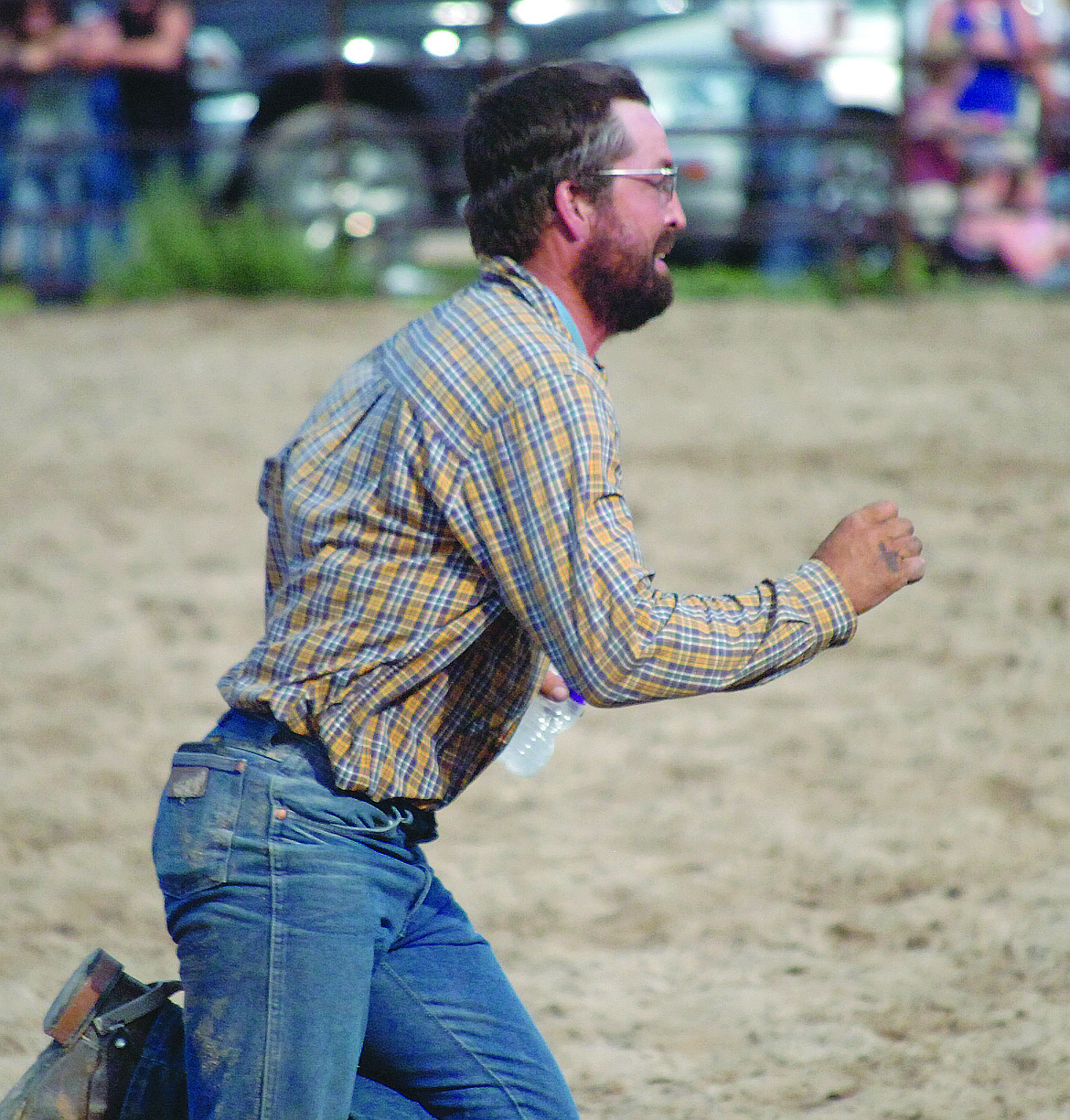 Josh Senecal sprints to the judge to complete his team&#146;s run in wild cow milking to wrap up the Ranch Rodeo in Ronan. Senecal and his teammates Trevor Motichka, Paul Guentzler and Will Harris took the Ranch Rodeo title, sharing $750 in first-place money.