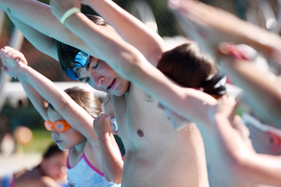 Swim instructor Emmett Van Allen goes over the basics of diving with a group of young swimmers at Woodland Water Park in Kalispell on Wednesday, July 18. (Casey Kreider/Daily Inter Lake)