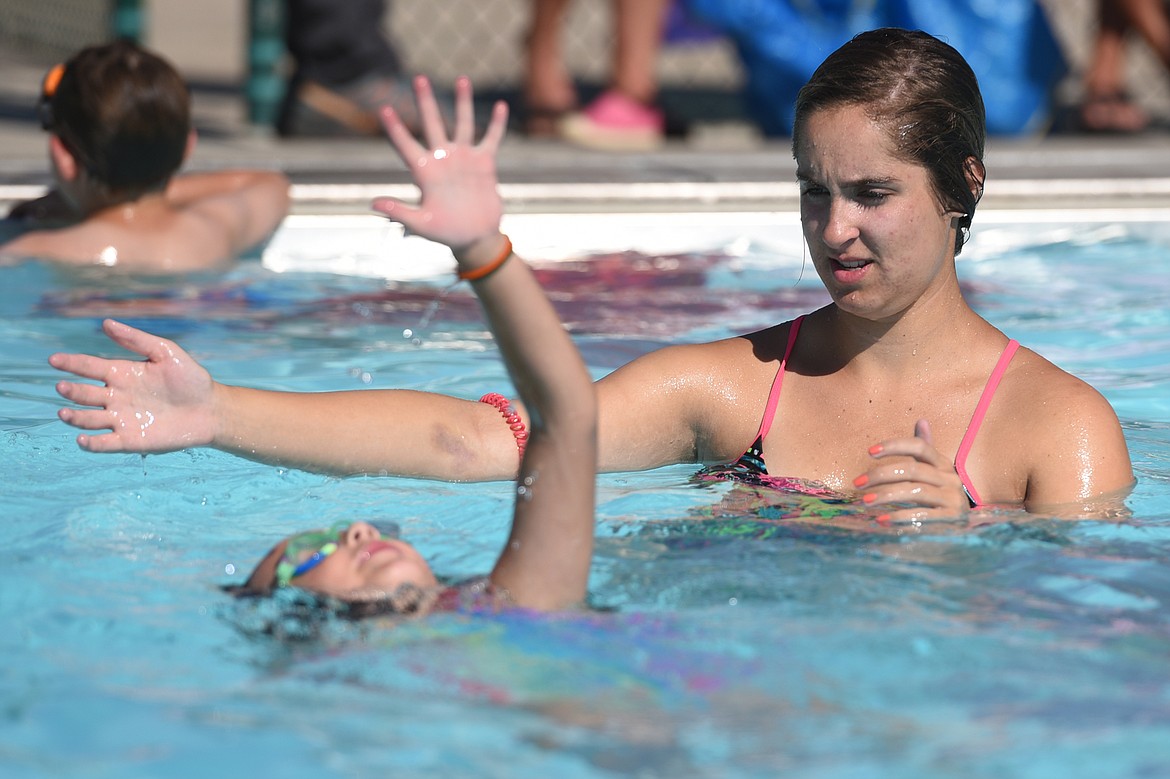 Swim instructor Hailey Fennell watches a young swimmer practice the backstroke during a lesson at Woodland Water Park in Kalispell on Wednesday, July 18. (Casey Kreider/Daily Inter Lake)