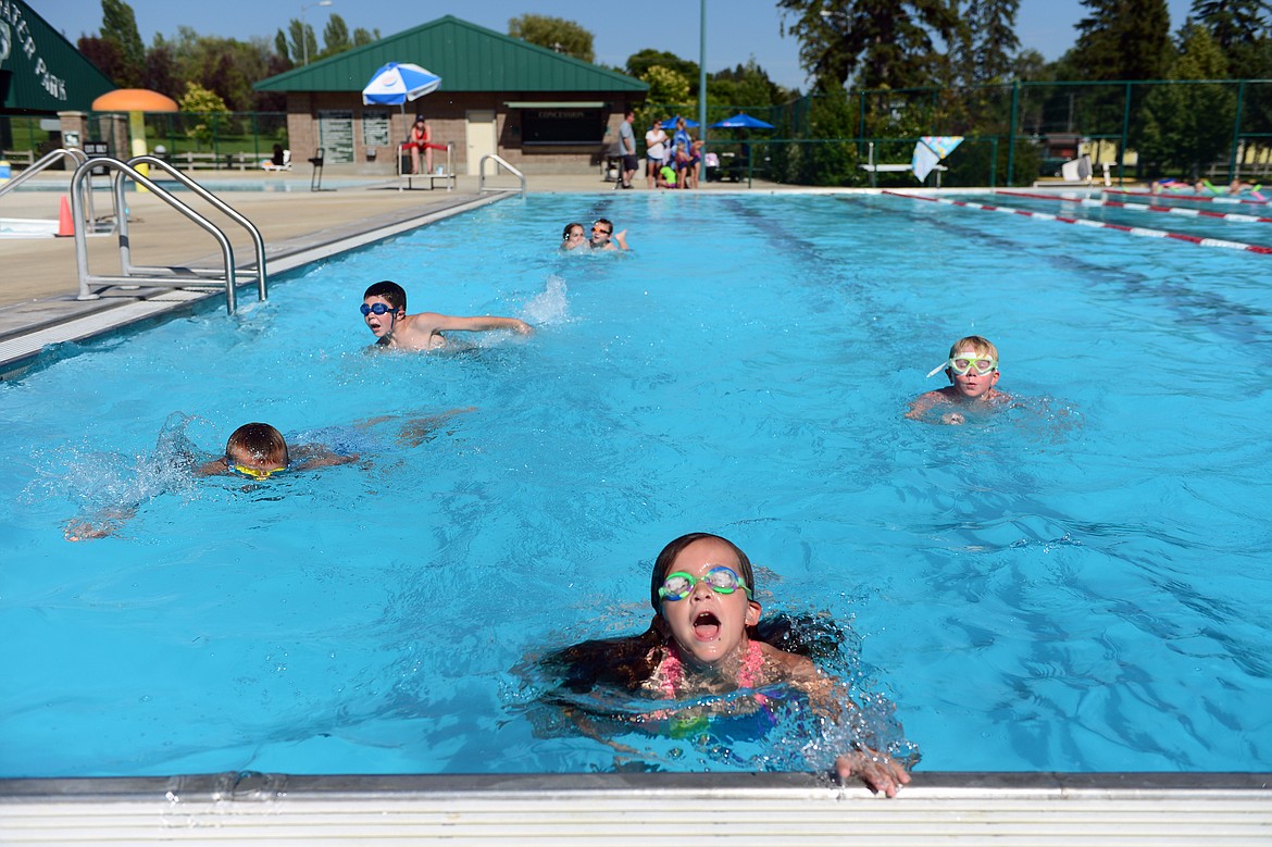 Young swimmers head to the opposite end of the pool to switch instructors during a swim lesson at Woodland Water Park in Kalispell on July 18. (Casey Kreider photos/Daily Inter Lake)