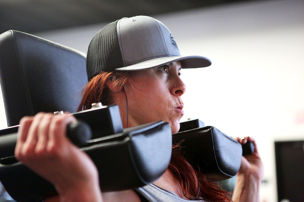 Kjersti Day lifts 234 pounds on a machine at Fuel Fitness. (Mackenzie Reiss/Daily Inter Lake)