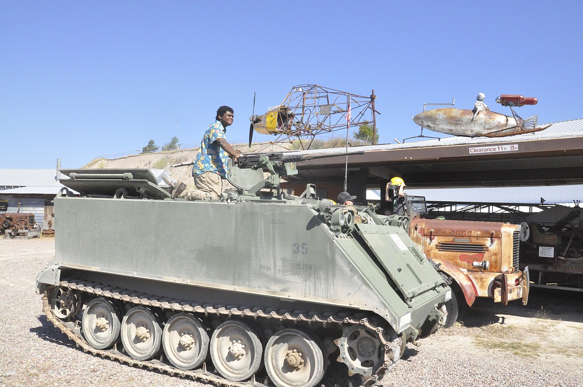 ELIJAH CAMEL, 17, of Pablo, rides a tank at Live History Days in Polson at The Miracle of America Museum Saturday, July 21. Camel volunteered at the event, showing visitors how different equipment once worked. (Ashley Fox/Lake County Leader)