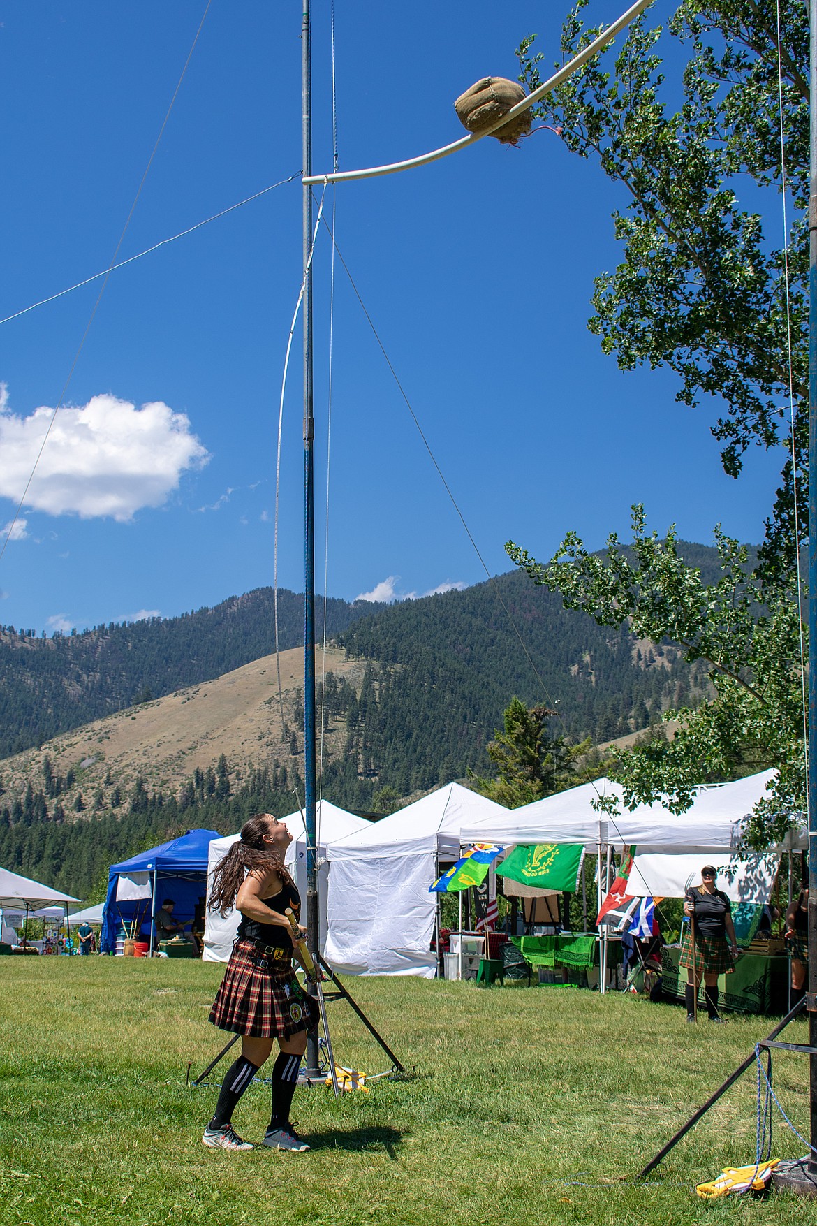 Amy Williams from Hamilton watches her sheaf hang on the bar just before going over during the sheaf toss at the 2018 Kootenai Highlanders Gathering Saturday.