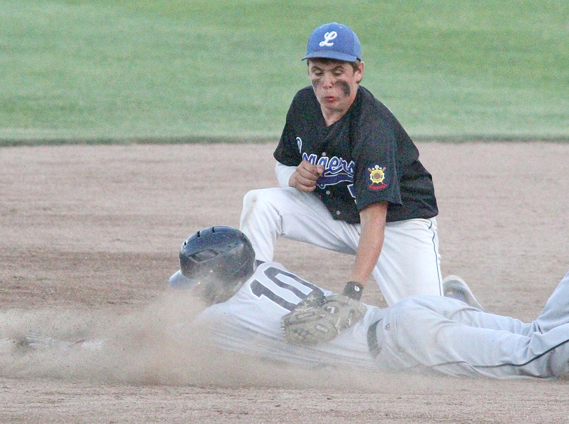 Austin McCully puts the tag on Bridger Johnson as he tries to steal second, top of sixth inning, in the second of a doubleheader. (Paul Sievers/The Western News)