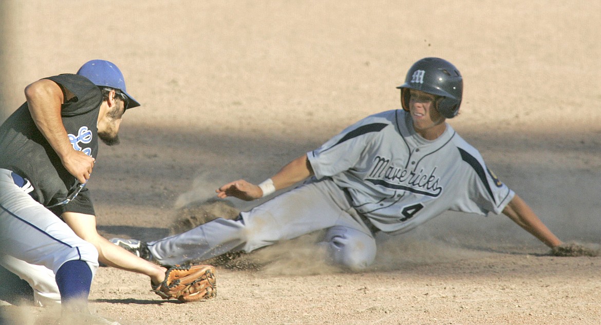 Shortstop Tim Carvey puts the tag on Missoula&#146;s Brent DeMinck attempting to steal third, top of 10th, in the first of a doubleheader. (Paul Sievers/The Western News)