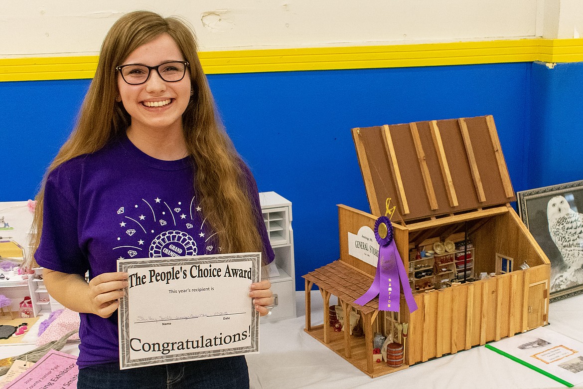 Shelby Smith stands next to her Grand Champion exhibit of the Jennings General Store Saturday during Lincoln County Junior Fair at the former Asa Wood school building in Libby. (Ben Kibbey/The Western News)