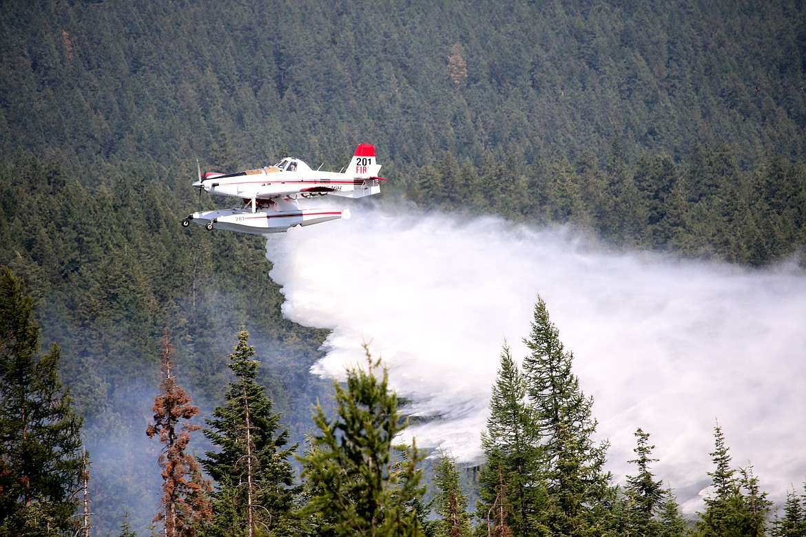 Photos by MANDI BATEMAN
Plane dumps a load of water on the 15-acre fire north of Bonners Ferry.