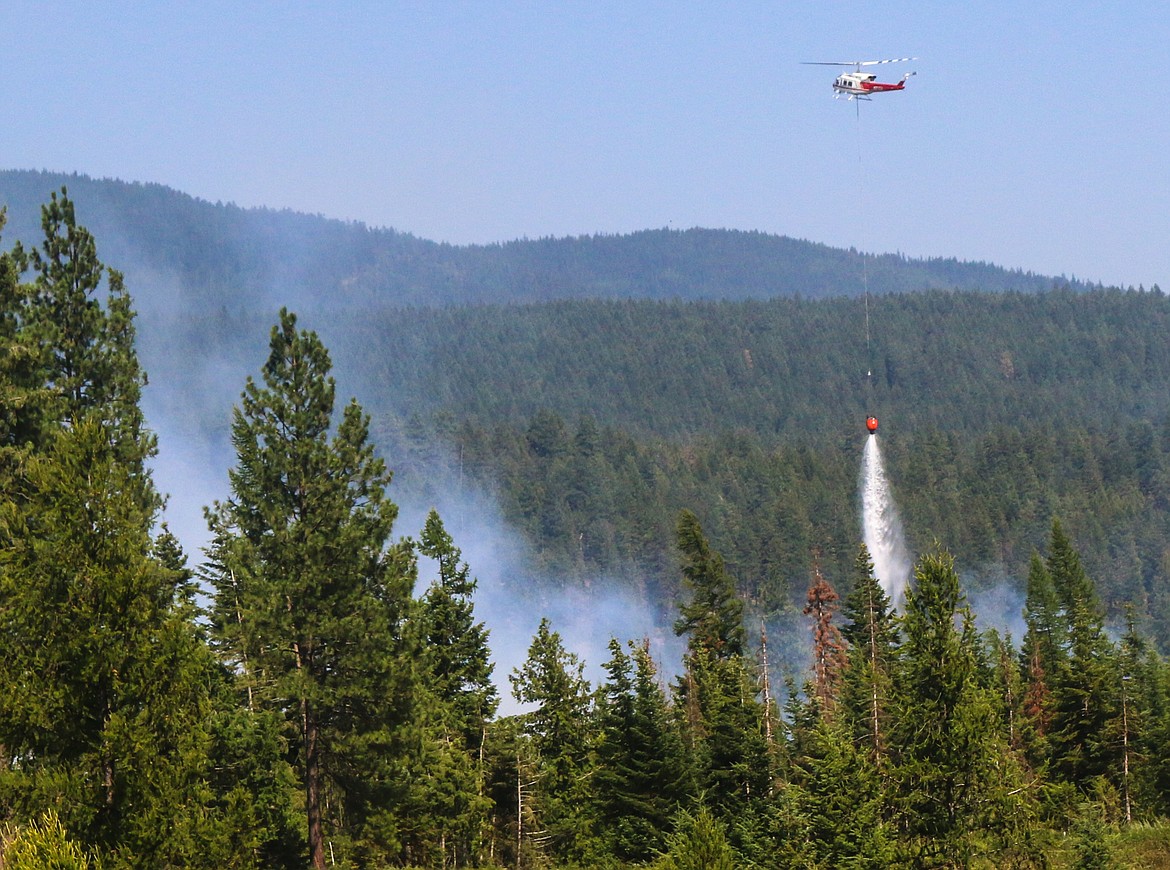 Photo by MANDI BATEMAN
The helicopter dropped load after load of water on the fire.