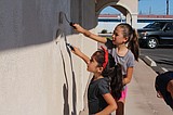 Painting party removes graffiti