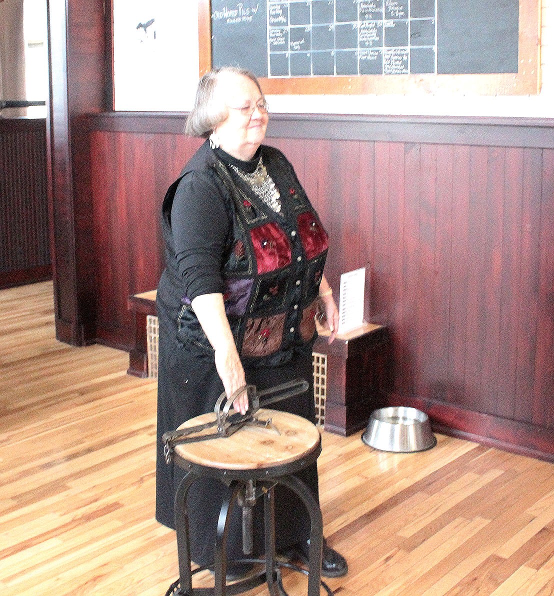 Rev. Mary Alice Jones places her hand in a trap as part of a magic act at a Smelter City Brewery pint night fundraiser for Pintler Suicide Awareness and Prevention, a nonprofit volunteer organization in Anaconda that, as part of its overall mission, provides free education classes on mental health first aid. (James S. Rosien/The Anaconda Leader)