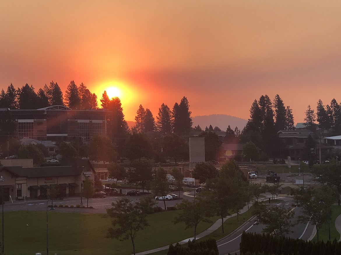 Smoke from fires in Washington, Canada and Oregon blanketed North Idaho on Friday morning. Tim Smith took this sunrise photo with is iPhone from his balcony in Riverstone.

(Photo courtesy 
TIM SMITH)