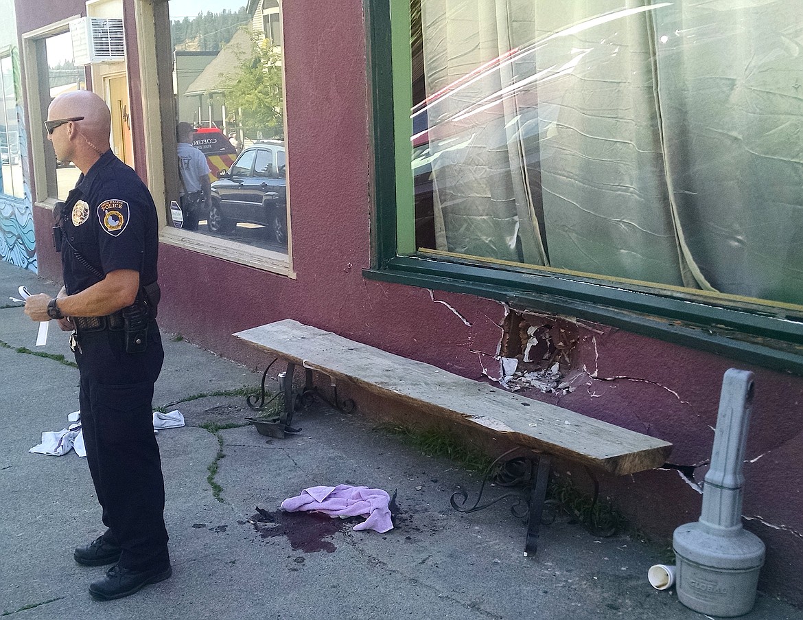 BRIAN WALKER/Press
A Coeur d&#146;Alene Police officer clears the scene for an investigation of where a vehicle jumped a curb, injured Jim Lawson and damaged the Second Street Commons building in downtown Coeur d&#146;Alene on Thursday afternoon. The building has been shut down by the city until it is deemed safe.